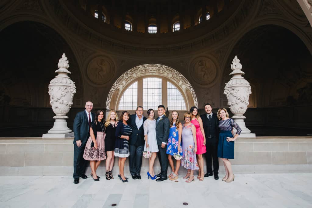 A group of people posing in front of an ornate building.