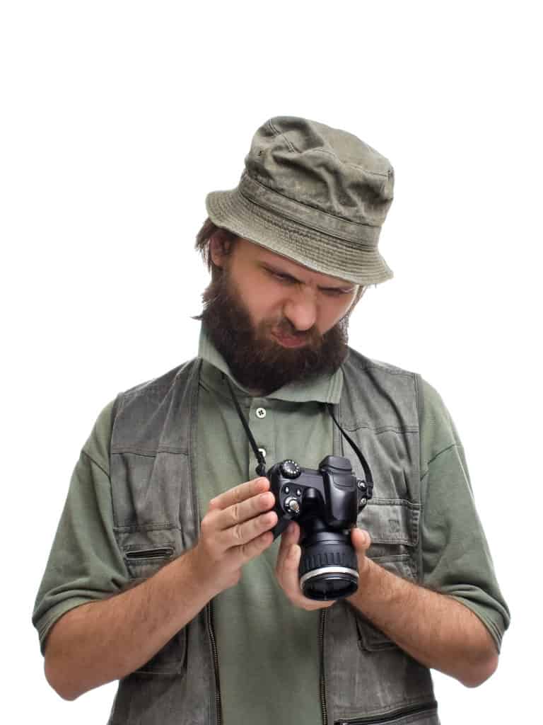 A man with a beard holding a camera.