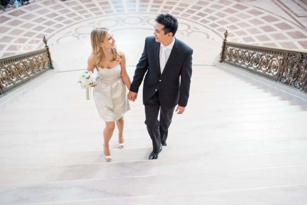 San francisco bride and groom walking down the stairs.