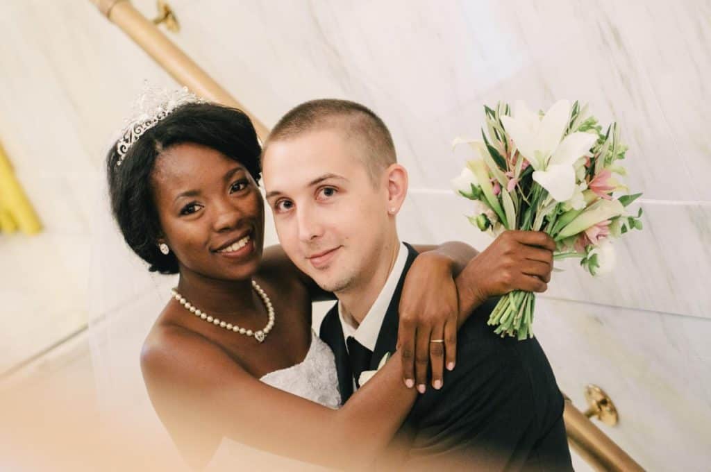 A bride and groom posing for a wedding photo.