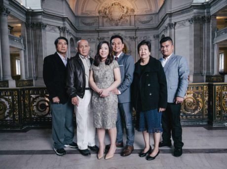 A group of people posing for a picture in an ornate building.