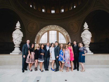 A group of people posing in front of an ornate building.