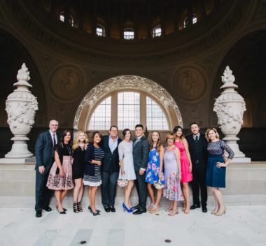 A group of people posing in front of an ornate building.