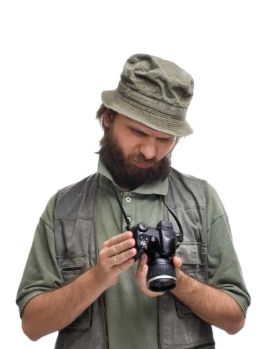 A man with a beard holding a camera.